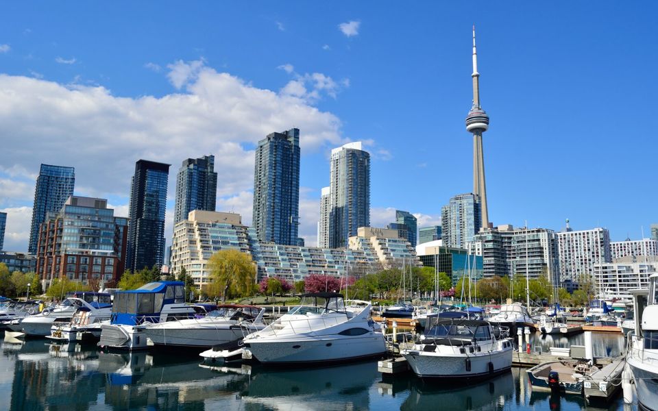 The Toronto skyline and CN Tower rising above boats moored at the Harbourfront marina
